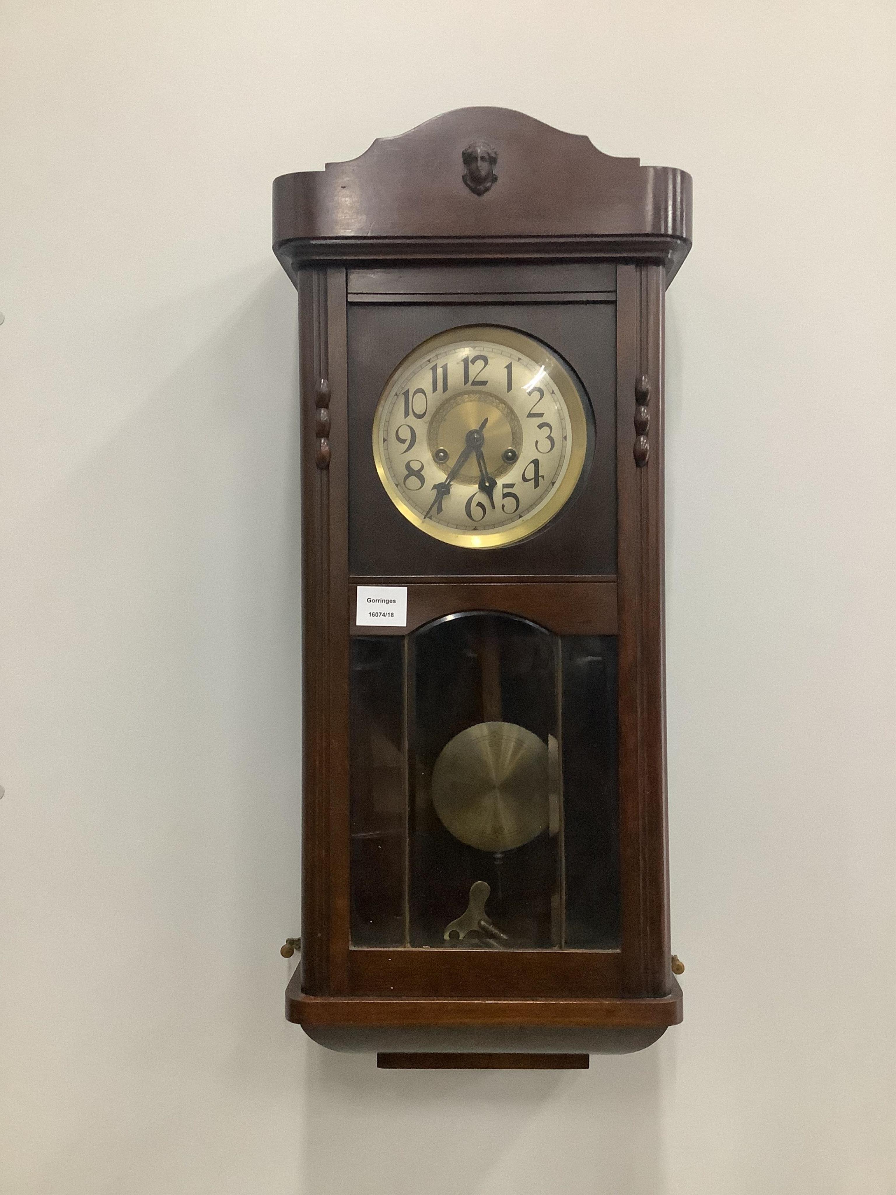 A 1930's stained beech eight day wall clock, height 77cm. Condition - good